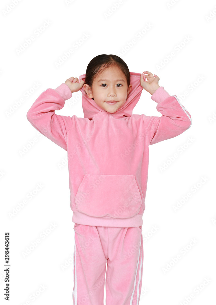 Portrait of little Asian child girl in pink tracksuit or sport cloth with putting hood on head isolated on white background. Portrait half-length of kid girl. Portrait of little Asian child girl in pink tracksuit or sport cloth with putting hood on head isolated on white background. Portrait half-length of kid girl.