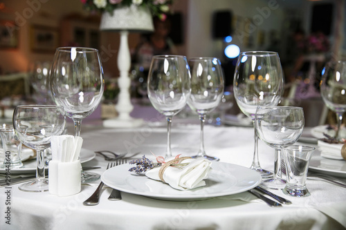 catering at a top event, glasses and flowers on the table, preparation for a significant event, beautiful dishes and glasses on the table, New Year's holiday table