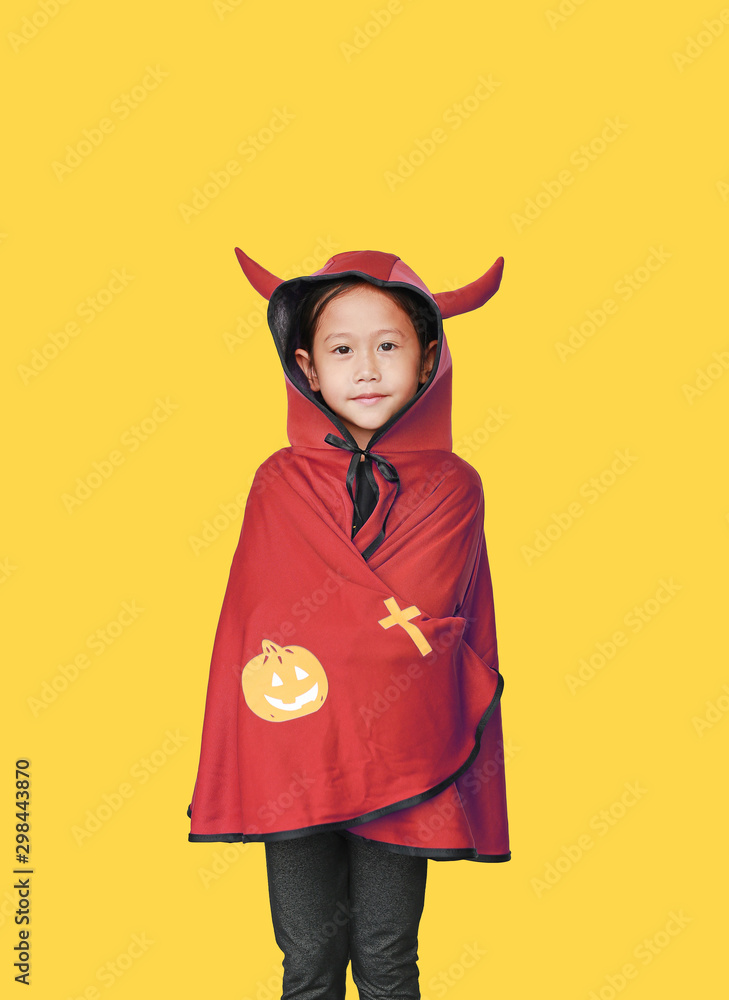 Portrait of little child girl dressed Halloween costume. Kid in Dracula coat isolated over yellow background. Portrait of little child girl dressed Halloween costume. Kid in Dracula coat isolated over yellow background.