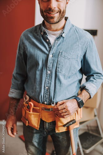 Smiling man in the process of home reparation stock photo