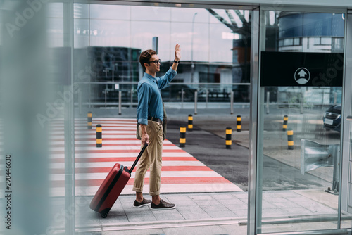 Man waving to somebody after arrival to airport stock photo