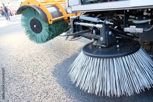 Routine sweeping of municipal streets and highways. Sweeping equipment.Combination of two sweeping brushes of street sweeper close up. © Matrix Reloaded
