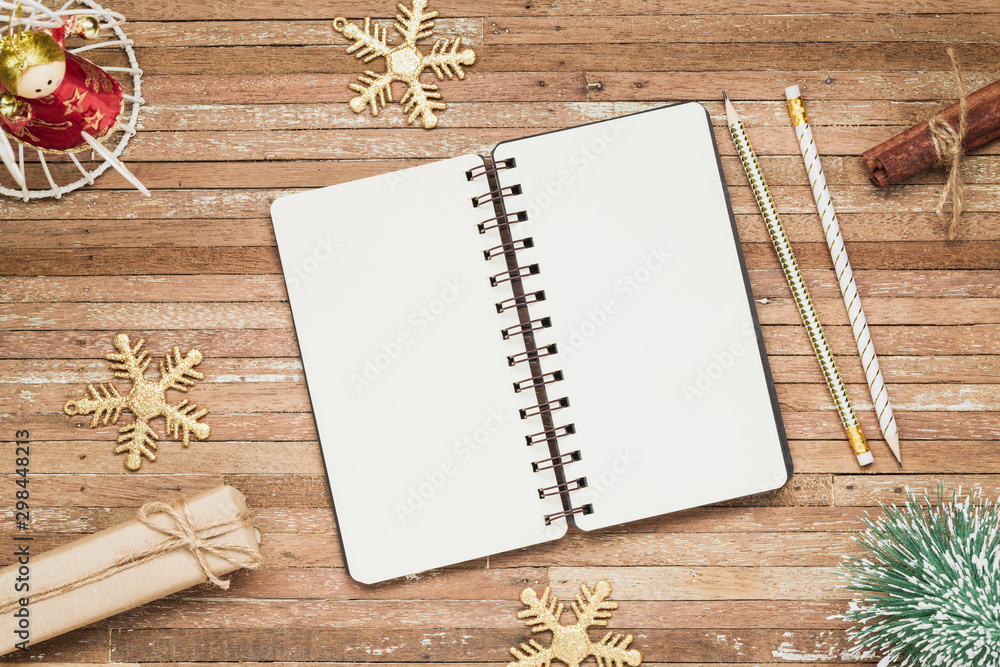 Top view of blank notebook on grunge wood background with Christmas decorations. Mockup xmas background with notebook for wish list or to do list. Flat lay with copy space. Top view of blank notebook on grunge wood background with Christmas decorations. Mockup xmas background with notebook for wish list or to do list. Flat lay with copy space.