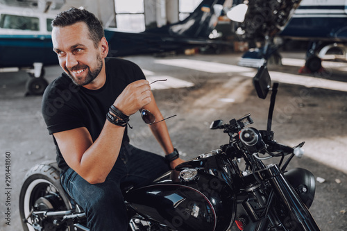 Caucasian smiling biker having fun in garage © Yakobchuk Olena