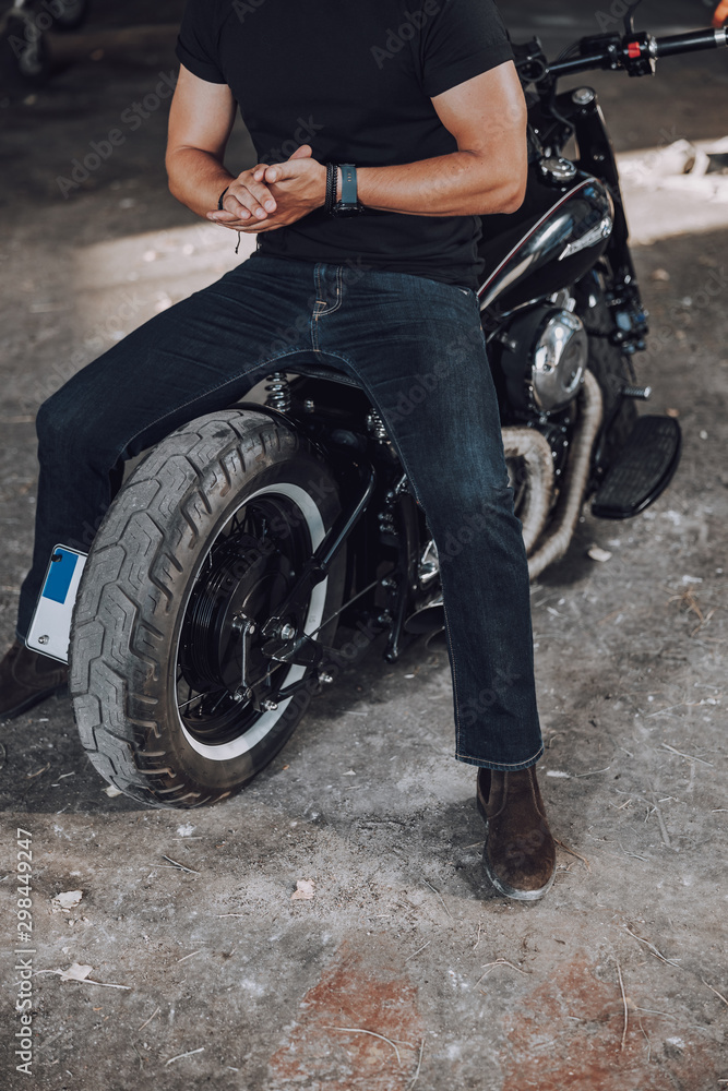 Caucasian guy is sitting of his motorbike Caucasian guy is sitting of his motorbike
