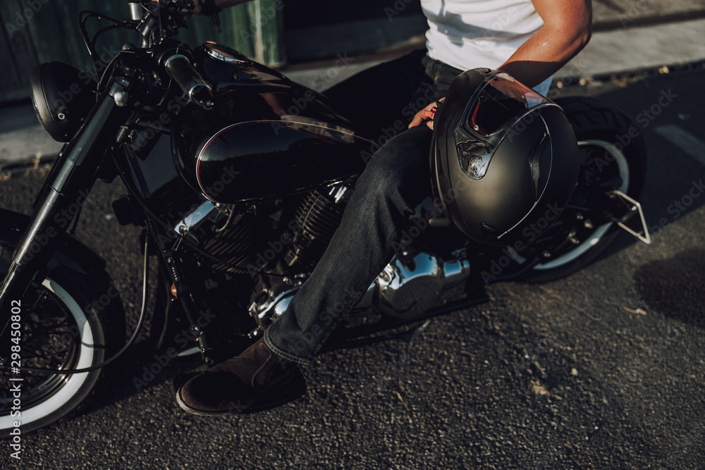 Caucasian man with helmet sitting on motorcycle Caucasian man with helmet sitting on motorcycle