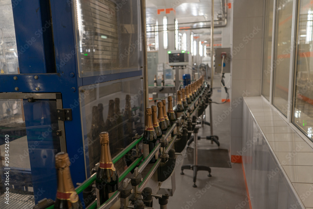 Obraz premium Champagne or sparkling wine bottles on the conveyor belt. Winery