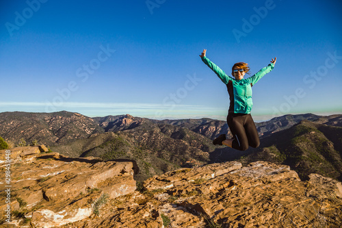Jumping young girl in the mountain