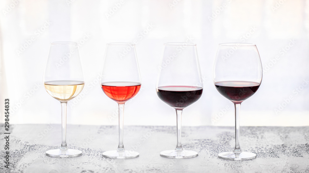 Glasses with different wine bordeaux, red, rose and white on white background. Beautiful wine variety concept. Glasses with different wine bordeaux, red, rose and white on white background. Beautiful wine variety concept.