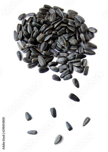 Black small sunflower seeds. Seeds in the shape of a heart and a month. Handful of seeds.