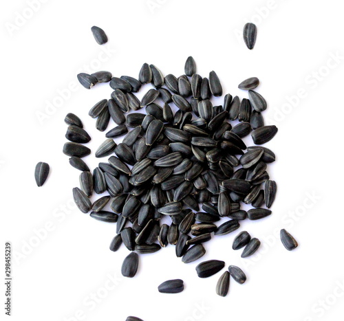 Black small sunflower seeds. Seeds in the shape of a heart and a month. Handful of seeds.