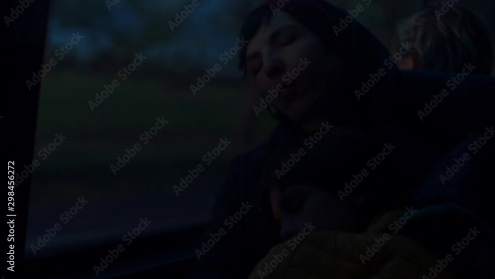A woman sleeps in a bus chair early in the morning. Around the darkness. A woman sleeps in a bus chair early in the morning. Around the darkness.
