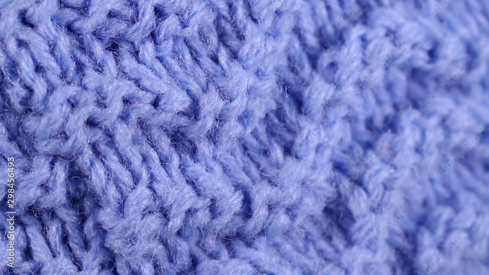 piece of knitted blue fabric rotates slowly. background piece of knitted blue fabric rotates slowly. background