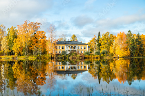 Kouvola, Finland - 8 October 2019: Autumn landscape with beautiful wooden Rabbelugn Manor - Takamaan Kartano. Wrede family house was built in 1820 on the river Kymijoki bank.