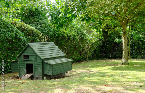 Small chicken coop seen erected within a domestic garden as seen in mid summer.