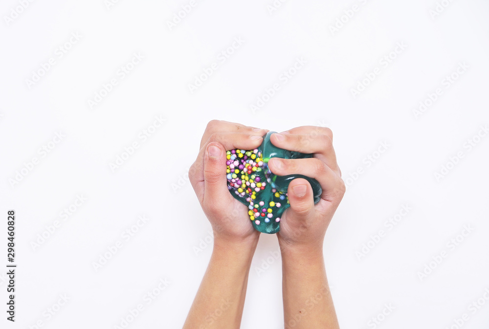 Blue slime in child hands on white background. Blue slime in child hands on white background.