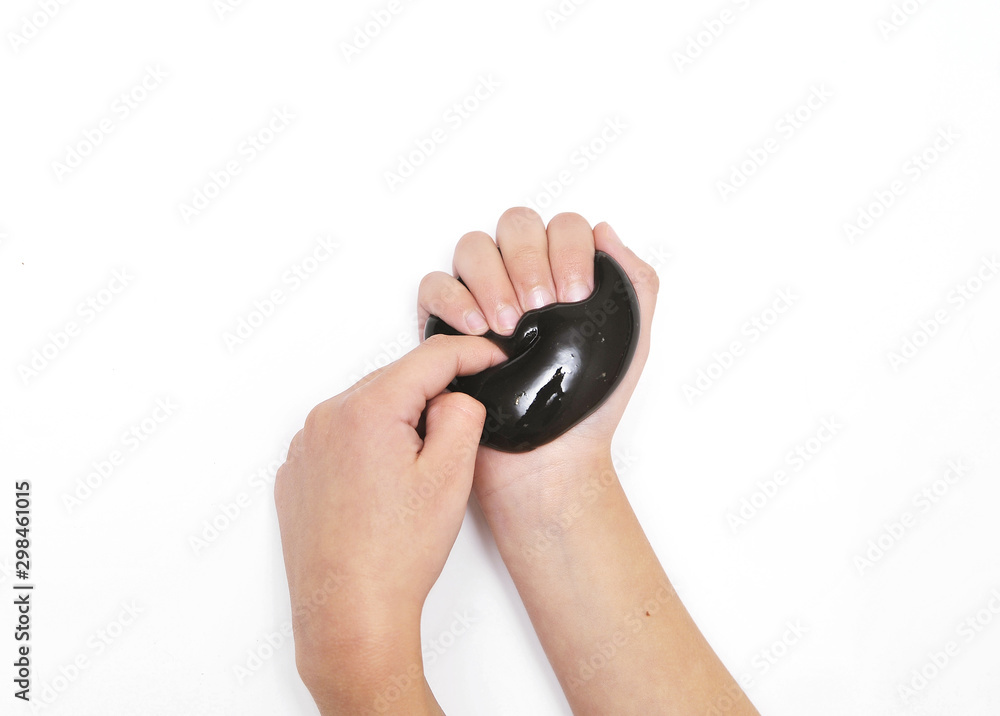 Fototapeta premium Violet slime in child hands on white background.