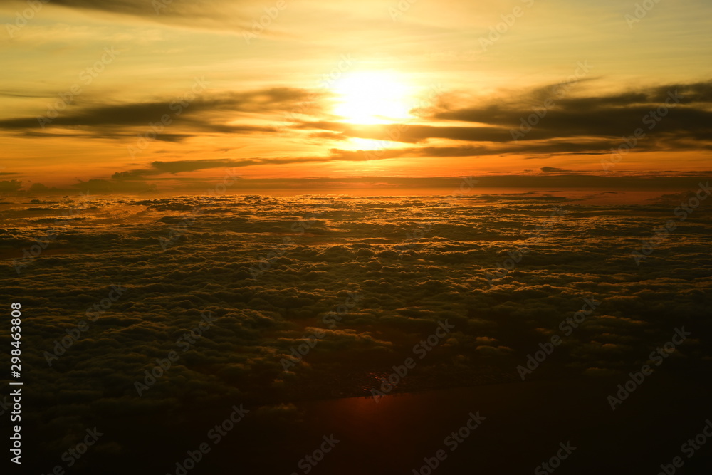 Golden yellow sky and beautiful clouds. During the setting sun Viewed from a high angle on the plane