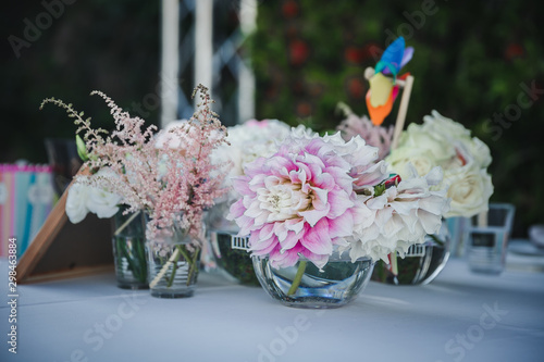 catering at a top event  glasses and flowers on the table  preparation for a significant event  beautiful dishes and glasses on the table  New Year s holiday table