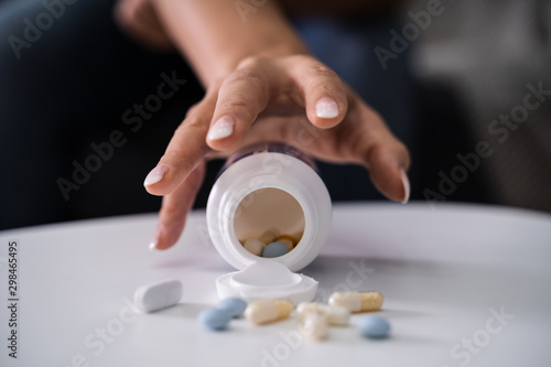 Drug Addicted Woman Reaching For Medication photo