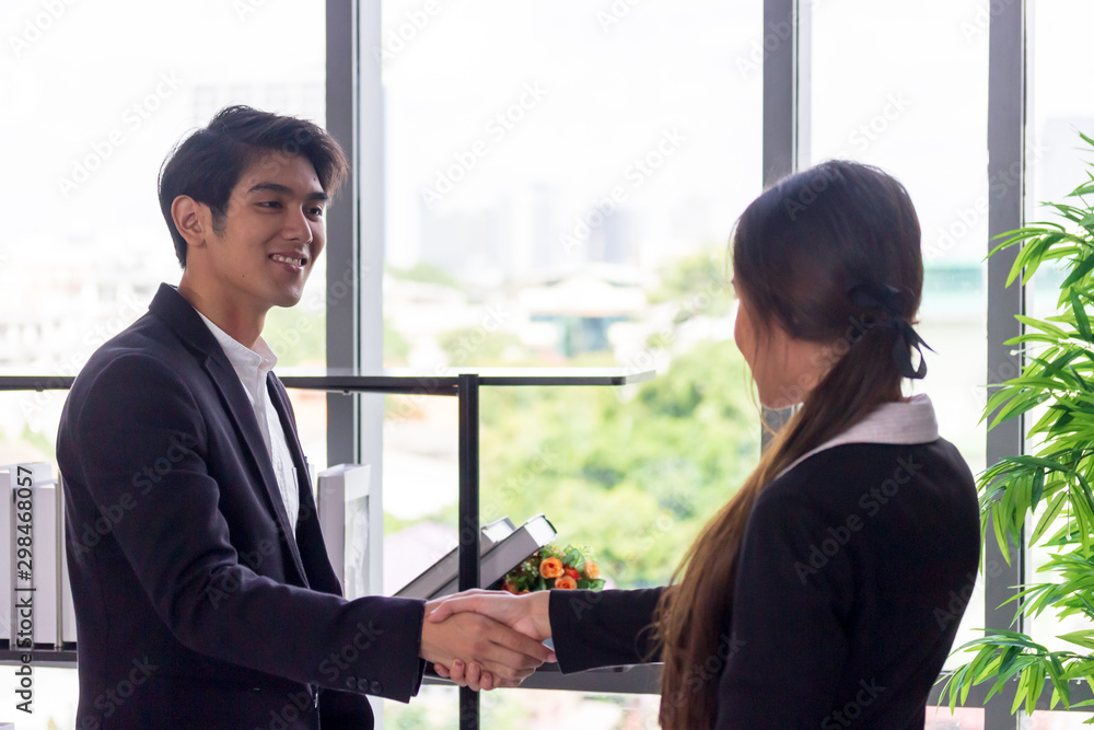 Young Asian businessmen join hands with business women in the office. Young Asian businessmen join hands with business women in the office.