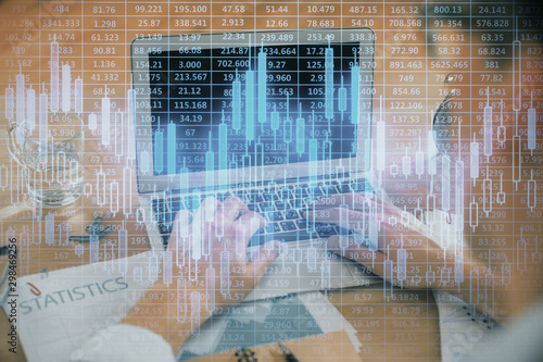 Multi exposure of market chart with man working on computer on background. Concept of financial analysis.