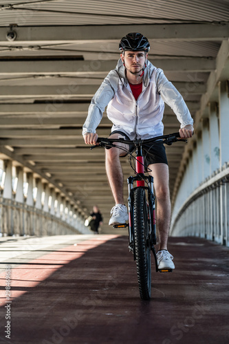 Young man biking in city
