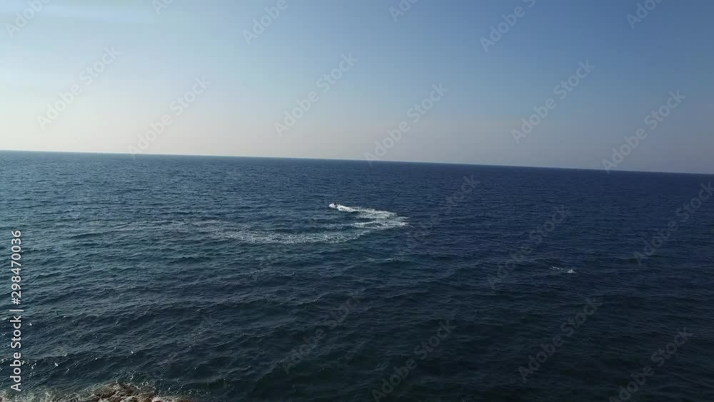 Top view aerial drone shot of jetski on blue sea Top view aerial drone shot of jetski on blue sea