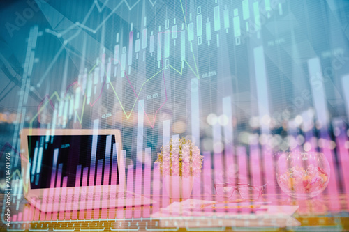 Forex graph hologram on table with computer background. Double exposure. Concept of financial markets.