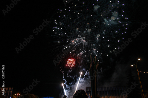 Crowd watching fireworks and celebrating, beautiful fireworks light up the sky, New Year celebration fireworks