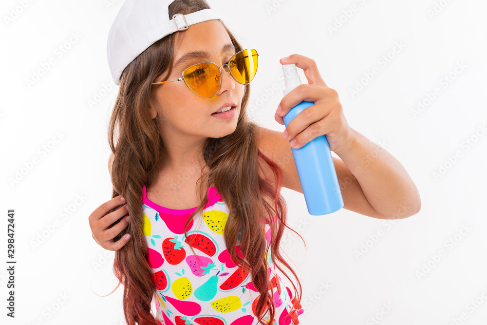 caucasian girl with long crucified hair in sunglasses and swimsuit sprays water, refreshes air isolated on white background caucasian girl with long crucified hair in sunglasses and swimsuit sprays water, refreshes air isolated on white background
