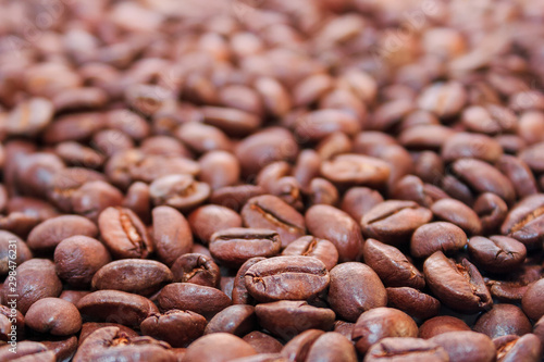 roasted coffee beans background. arabica and robusta mix. shallow depth of field