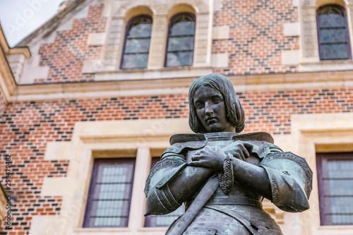 Statue of Jeanne D arc in front of Hotel Groslot , in use as town hall in Orleans France photo