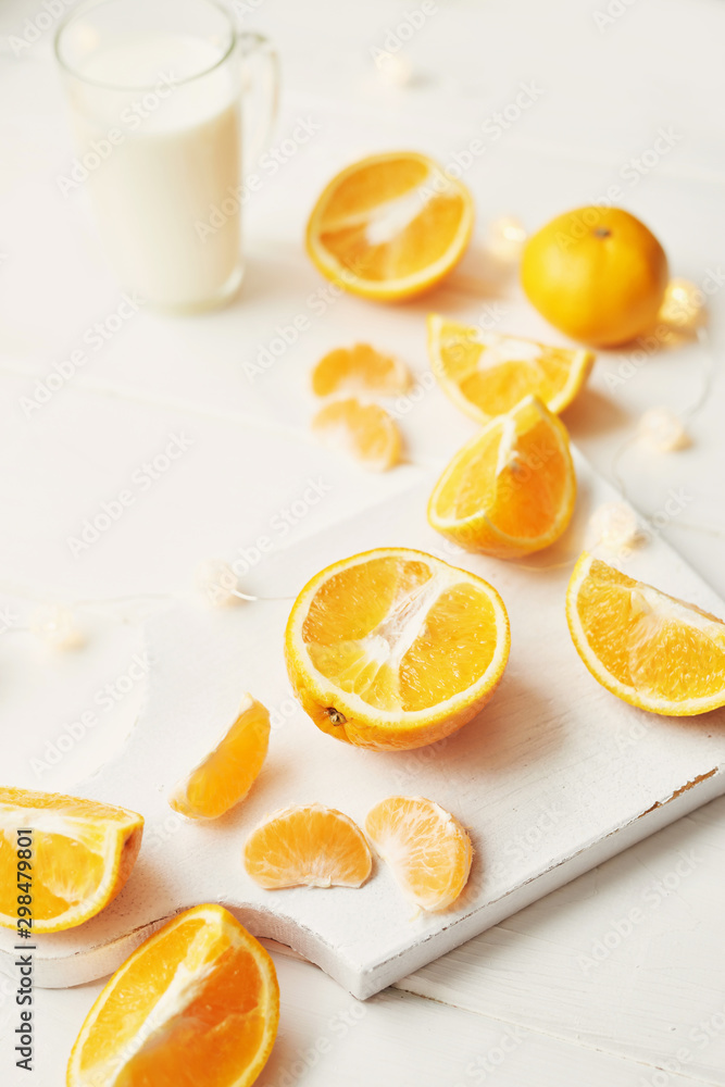 Christmas oranges and tangerines on a white background by the window Christmas oranges and tangerines on a white background by the window