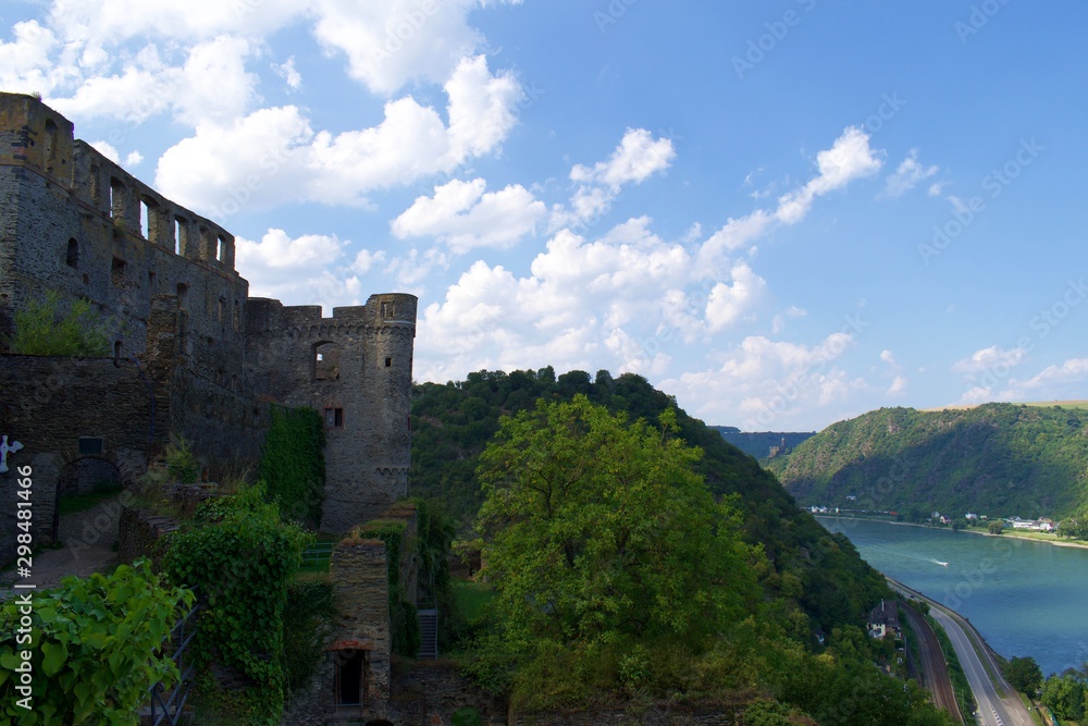 Looking at castle ruins on hill with river in background Looking at castle ruins on hill with river in background