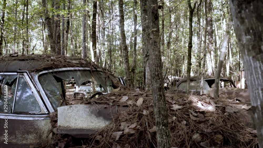 Old Antique Rusty Car Abandoned And Forgotten In Junkyard In The Woods. Broken Windshield And Windows. Old Antique Rusty Car Abandoned And Forgotten In Junkyard In The Woods. Broken Windshield And Windows.