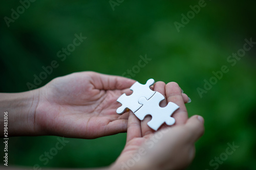 Hands and puzzles, important pieces of teamwork Teamwork concept