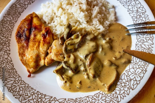 Chcicken steak, mushroom sauce and rice. photo