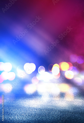 Empty abstract background. Reflection of blurry city lights on asphalt, smoke, bokeh. Neon multi-colored lights. © Laura Сrazy
