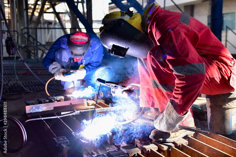 Two welder is assembling the workpiece by process shielded metal arc
