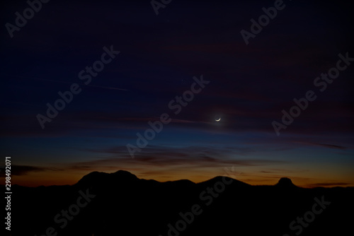 Moon at Dusk over Desert Mountains