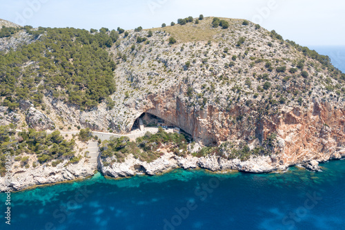 Rock with the entrance to the cave of Arta on the island of Mallorca photo