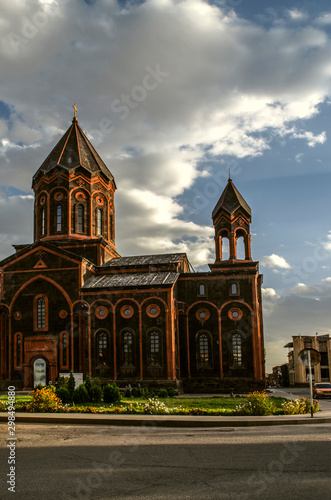  West side with bell tower on the Church "Amenaprkich" of the Holy Savior on the background of the evening sky in Gyumri