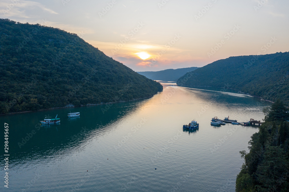 Sunset over the water channel. There is an oyster farm on the canal. Shooting from a drone. Istria, Croatia.