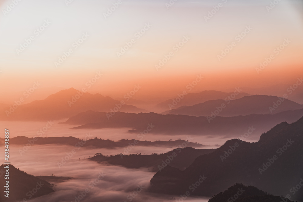 Mountains covered with fog at sunrise Mountains covered with fog at sunrise