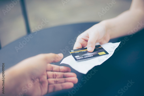 Lady, women hand holding credit card and receipt, bill or order invoice, ready to pay