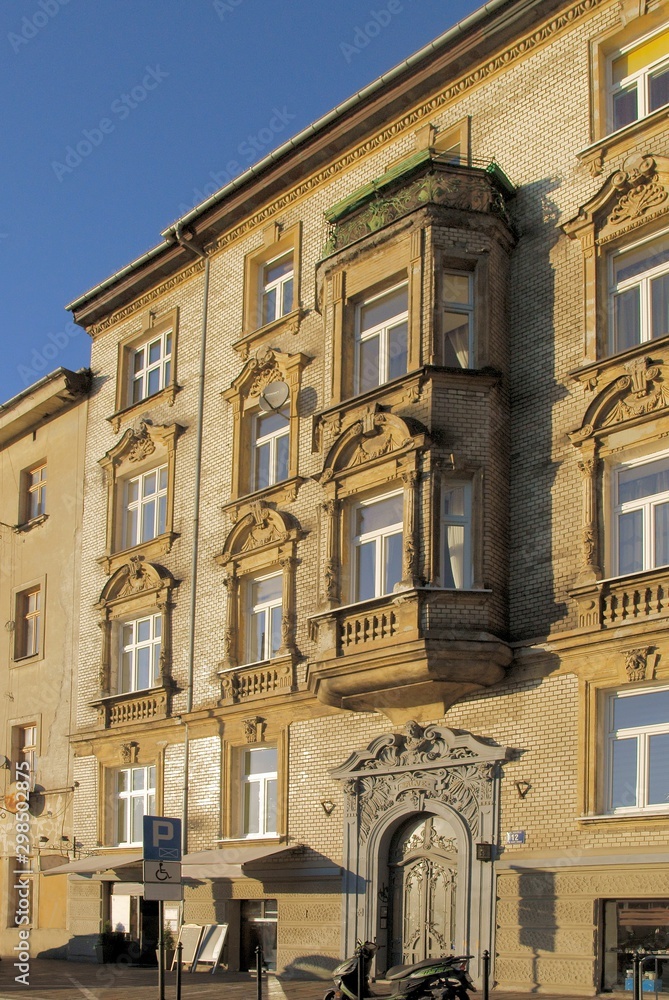 Fototapeta premium pretty decorated facades of old buildings in Krakow center
