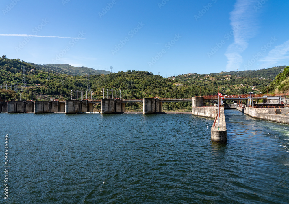 Solid structure of the Carrapatelo dam on River Douro in Portugal with the lock gates on the right
