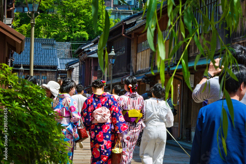 Three geisha walking together in the streets of Kanazawa, Higashi Chaya district