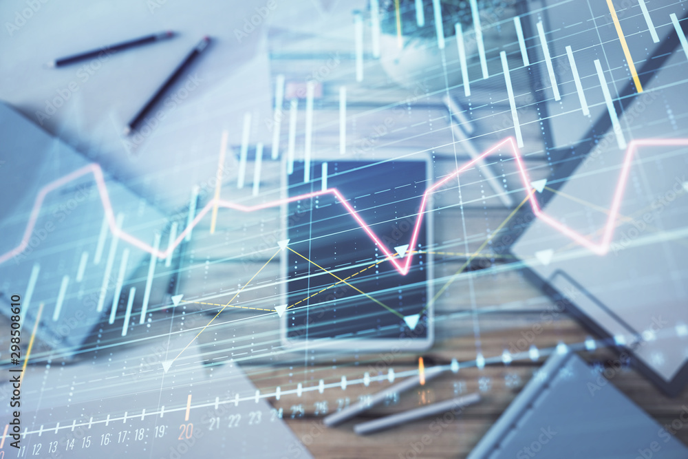 Double exposure of forex graph on digital tablet laying on table background. Concept of market analysis Double exposure of forex graph on digital tablet laying on table background. Concept of market analysis